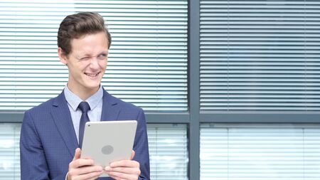 Happy Businessman Using Tablet and Having Funの写真素材