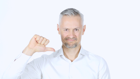 Thumbs Down By Middle Aged Businessman , White Backgroundの写真素材