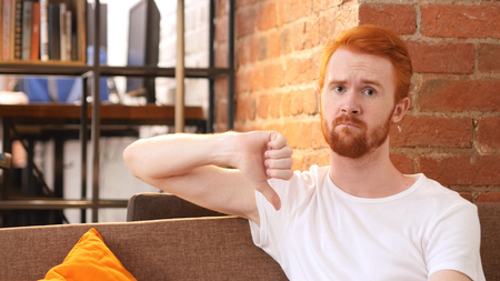 Man gesturing thumbs downの写真素材