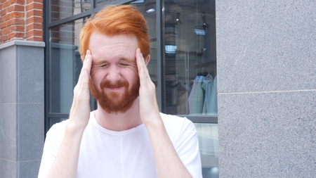 Frustrated Man with Headache, Standing Outdoor , Red Hairsの写真素材