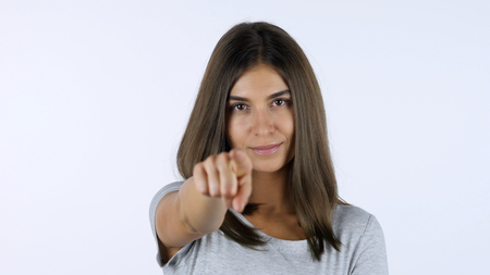Pointing Finger of Girl toward Camera, White Background in Studioの写真素材
