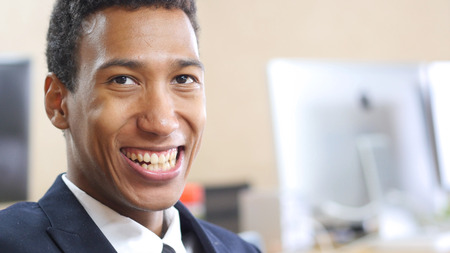 Portrait Of Smiling Arfo-American Businessman Sitting in Officeの写真素材