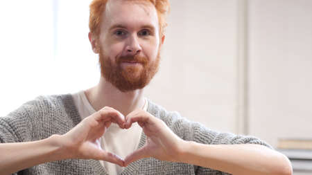 Heart Sign by Man with Red Hairsの写真素材