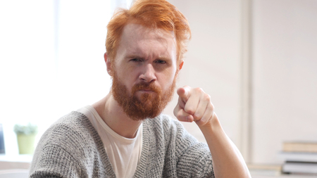 Man with Red Hairs Pointing Toward Cameraの写真素材