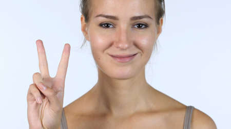 Victory Sign, Close up of Successful Beautiful Girl, White Backgroundの写真素材