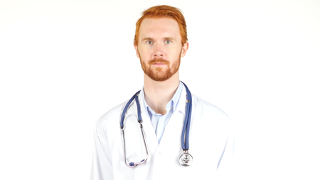 Doctor with stethoscope around his neck looking at the cameraの写真素材