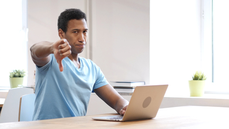 Thumbs Down by Black Man at Work, Both Handsの写真素材