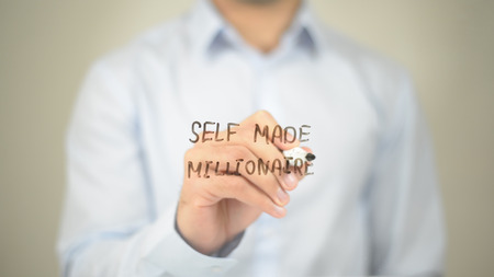 Self Made Millionare, Man Writing on Transparent Screenの写真素材
