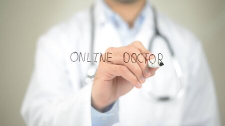 Online Doctor, Doctor writing on transparent screenの写真素材
