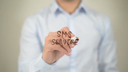 SMS Service  , man writing on transparent screenの写真素材