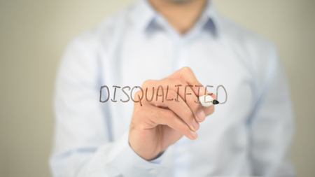 Disqualified , man writing on transparent screenの写真素材