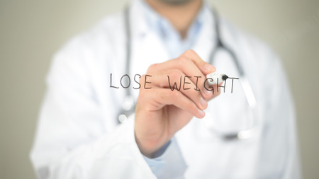 Lose Weight, Doctor writing on transparent screenの写真素材