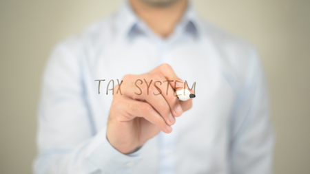 Tax System , man writing on transparent screenの写真素材