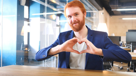 Heart Sign by Man with Red Hairsの写真素材
