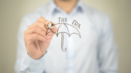 Tax Concept, Umbrella,  Man writing on transparent screenの写真素材