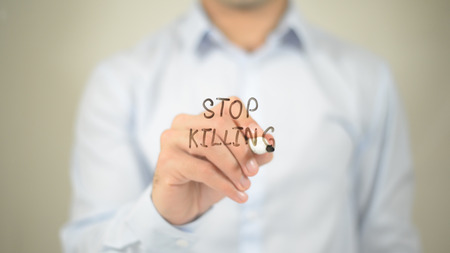 Stop Killing , man writing on transparent screenの写真素材