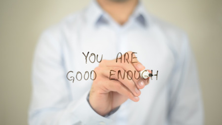 You Are Good Enough   ,  man writing on transparent wallの写真素材
