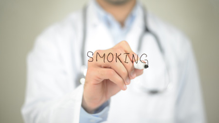 Smoking, Doctor writing on transparent screenの写真素材