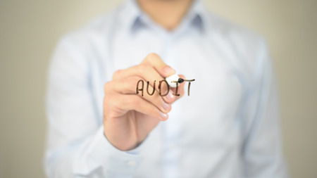 Audit,  Man writing on transparent screenの写真素材