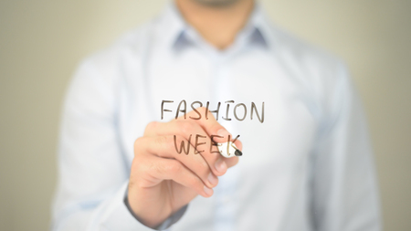 Fashion Week, man writing on transparent screenの写真素材