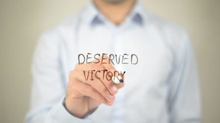 Deserved Victory   ,  man writing on transparent wallの写真素材