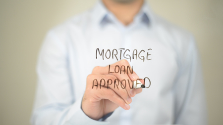 Mortgage Loan Approved , Man writing on transparent screenの写真素材