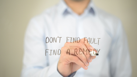 Don't Find Fault, Find a Remedy, Man writing on transparent screenの写真素材