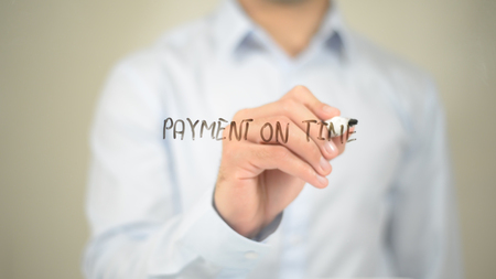 Payment on Time , Man writing on transparent screenの写真素材