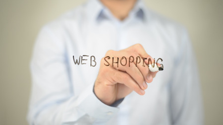 Web Shopping, man writing on transparent screenの写真素材
