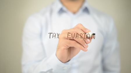 Tax Evasion , man writing on transparent screenの写真素材