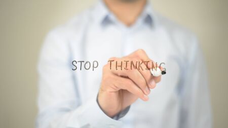 Stop Thinking, Man Writing on Transparent Screenの写真素材