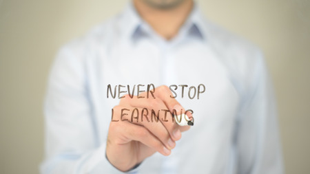 Never Stop Learning,  Man writing on transparent screenの写真素材