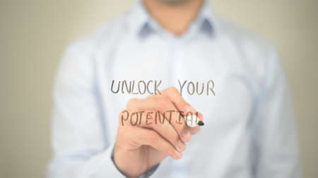 Unlock Your Potential, Man Writing on Transparent Screenの写真素材