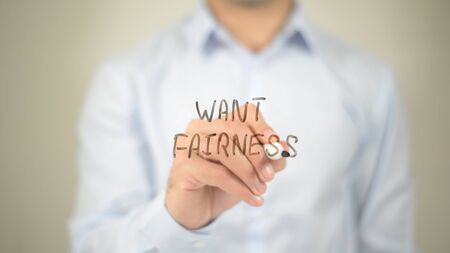Want Fairness , man writing on transparent screenの写真素材
