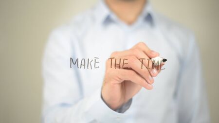 Make the Time , Man writing on transparent screenの写真素材