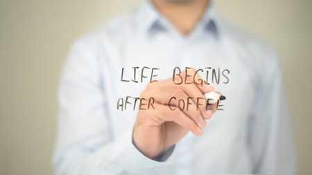 Life Begins after Coffee , Man writing on transparent screenの写真素材