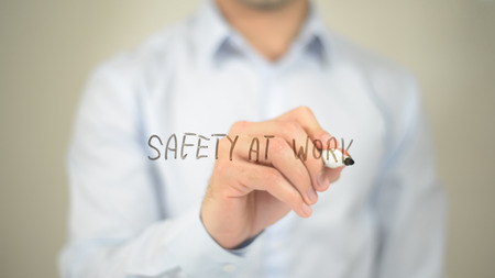 Safety at Work, man writing on transparent screenの写真素材