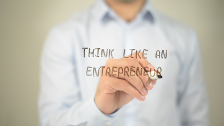 Think Like An Entrepreneur, man writing on transparent screenの写真素材