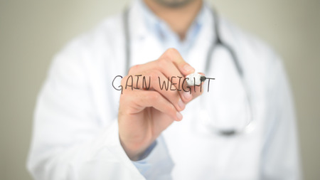 Gain Weight, Doctor writing on transparent screenの写真素材