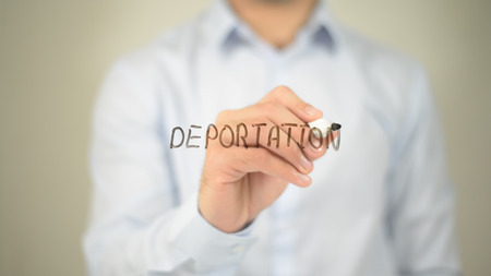 Deportation , man writing on transparent screenの写真素材
