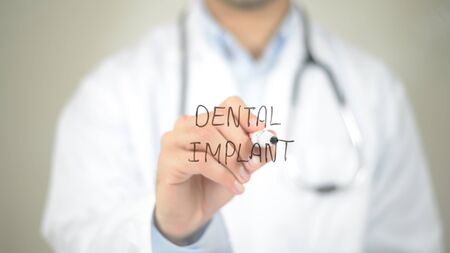 Dental Implant , Doctor writing on transparent screenの写真素材