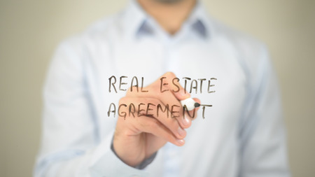 Real Estate Agreement   ,  man writing on transparent wallの写真素材