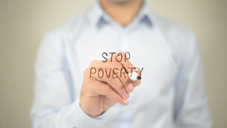 Stop Poverty , man writing on transparent screenの写真素材