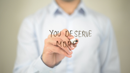 You Deserve More   ,  man writing on transparent wallの写真素材