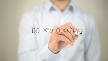 Do You Qualify, man writing on transparent screenの写真素材
