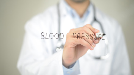 Blood Pressure , Doctor writing on transparent screenの写真素材