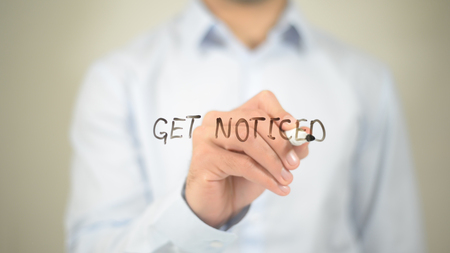 Get Noticed    ,  man writing on transparent wallの写真素材
