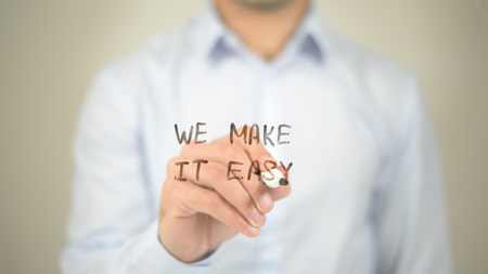 We Make it Easy,  Man writing on transparent screenの写真素材