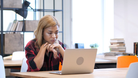 Afro-American Woman Busy Working on Laptopの写真素材