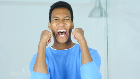 Afro-American Man Celebrating Success in His Office